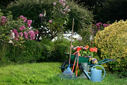 Workers wearing PPE preparing equipment for hedge trimming in Wood Green