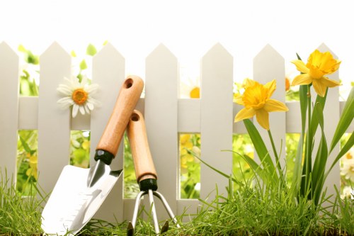 Skilled gardeners shaping hedges in a garden